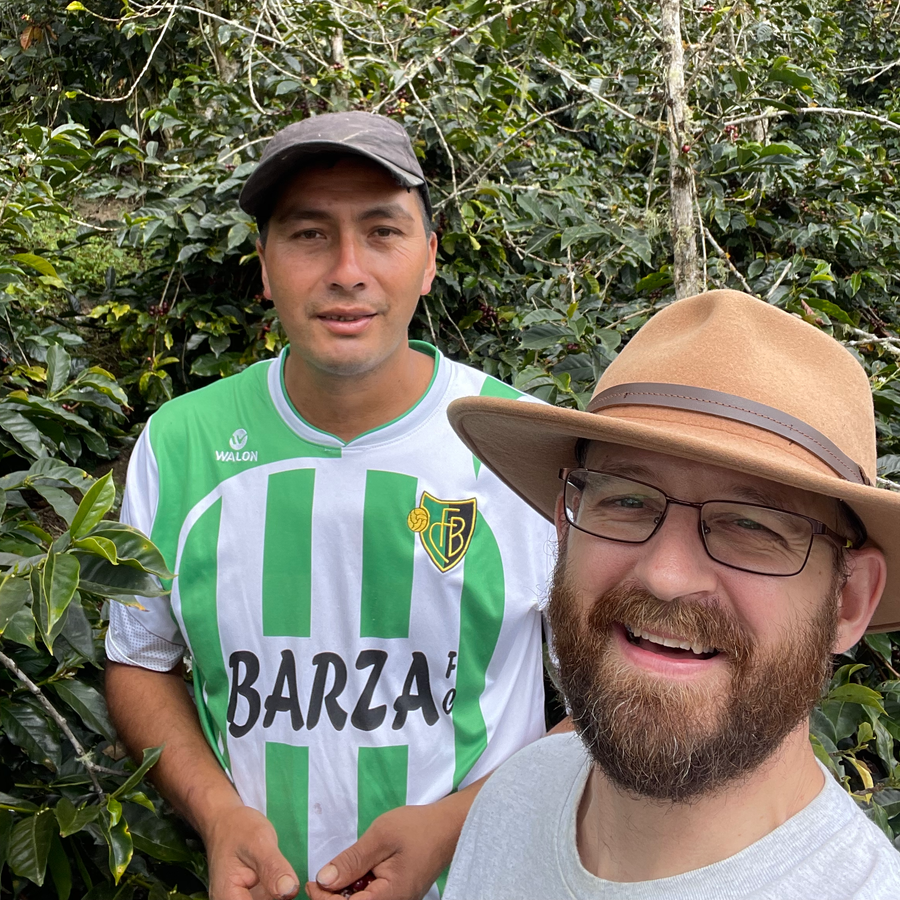 Einer Saldivar and Ozone Green Buyer Roland Glew pose together amongst coffee trees at El Cedro in Cajamarca, Peru