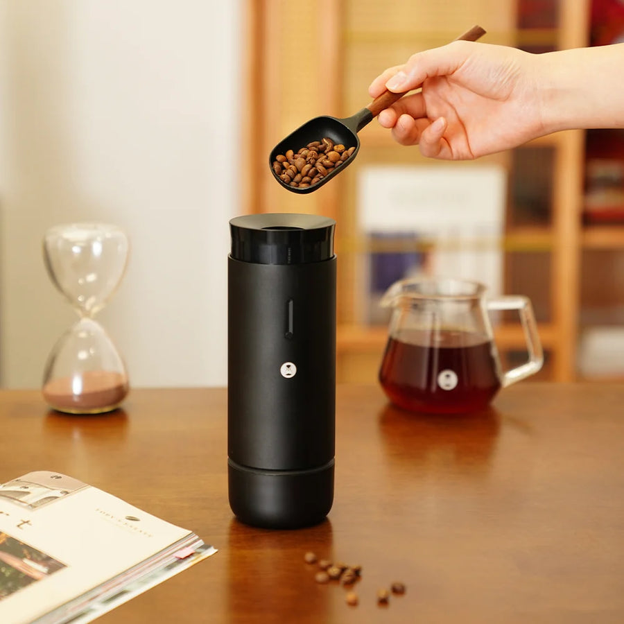Timemore Whirly 01S Portable Electric Coffee Grinder lifesyle shot showing beans being poured into the top of the grinder
