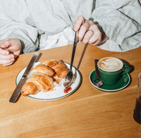 Acme Roman Cup Small (150ml) - Kawakawa (Green) loaded up with a tasty milky bev being enjoyed with a chopped up croissant